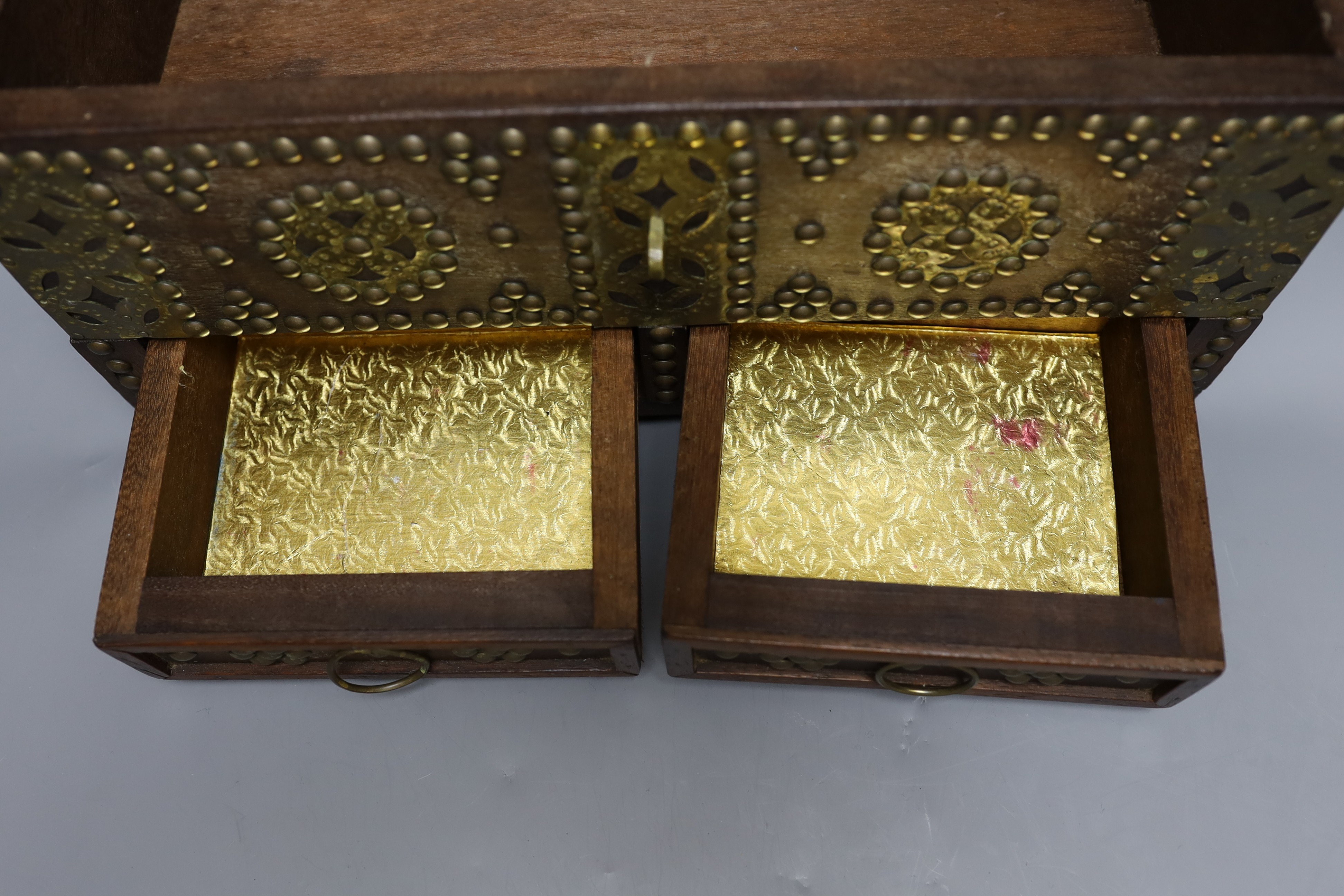 An Indian brass studded and mounted box, 45cms wide x 21cms high